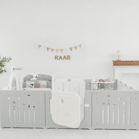 White and gray modular baby crib with RAAB banner